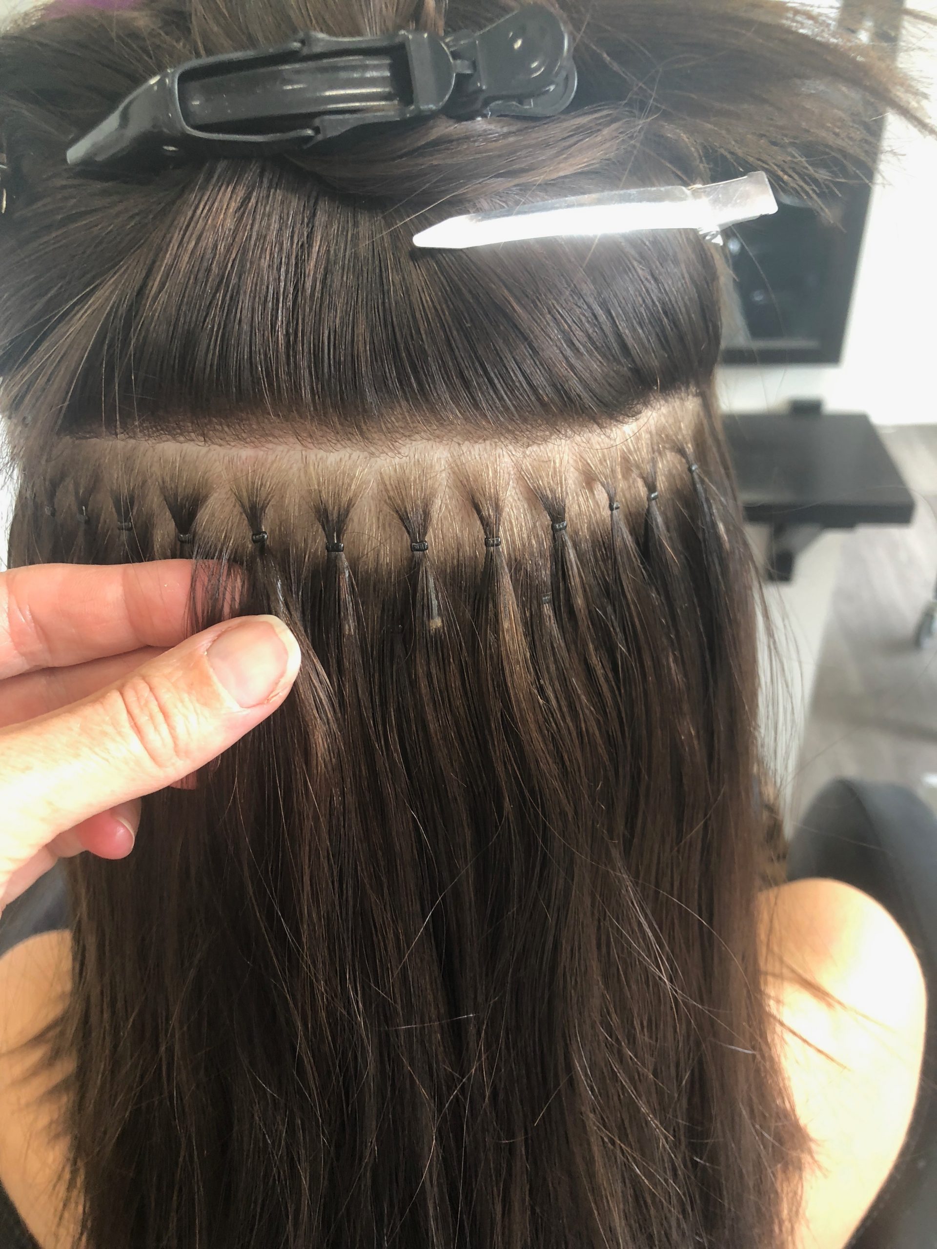 How are nano bead hair extensions applied?